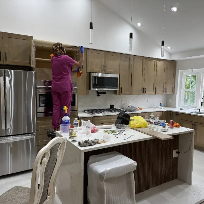 Super Clean team member detailing a modern kitchen