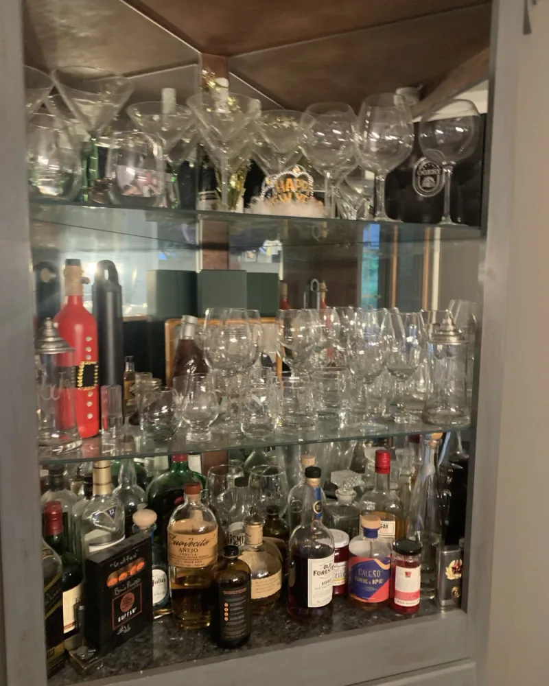 Glassware and bar shelves dusted and organized piece by piece