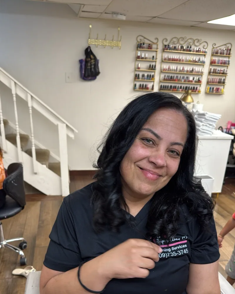 Rulyan Lima, co-owner of Super Clean, smiling in her Super Clean uniform
